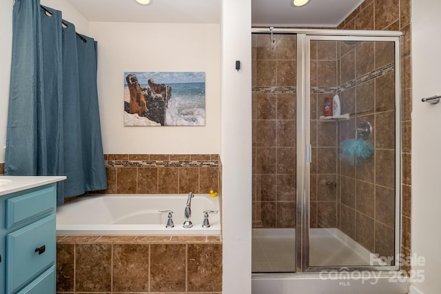 bathroom with a garden tub, vanity, and a shower stall