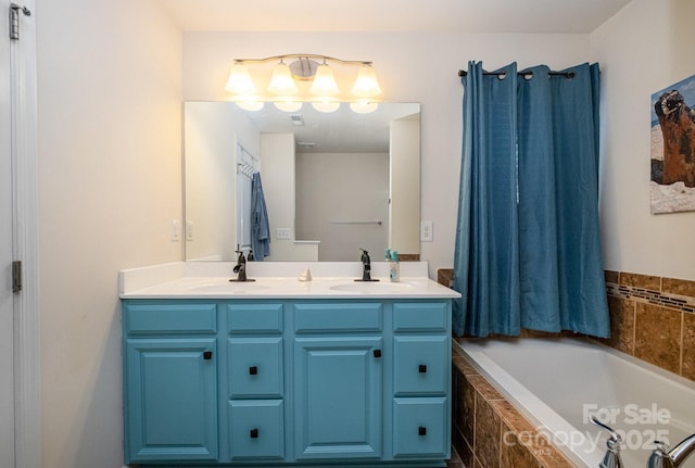 full bathroom with double vanity, a relaxing tiled tub, and a sink