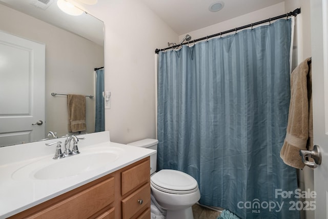 bathroom with toilet, visible vents, curtained shower, and vanity