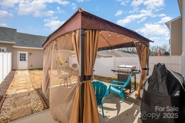 view of patio / terrace featuring a gazebo, a fenced backyard, and area for grilling