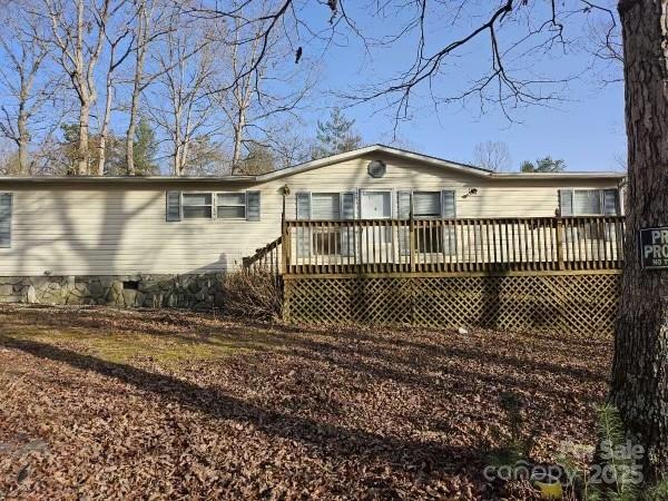 rear view of property featuring a deck