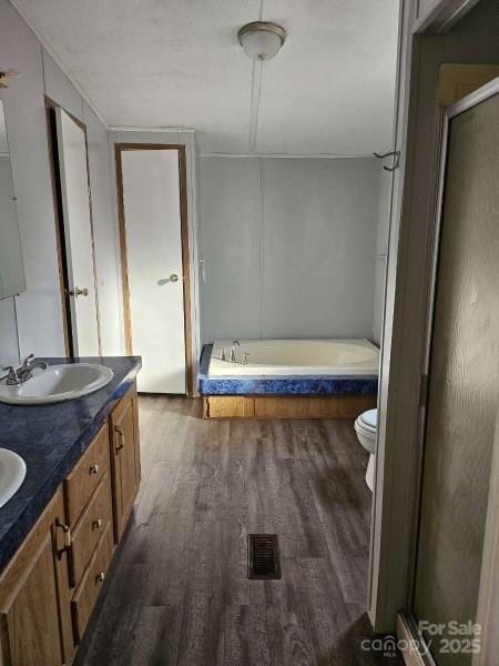 full bathroom featuring vanity, toilet, independent shower and bath, and hardwood / wood-style floors