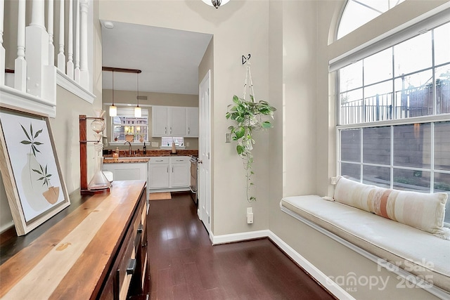 interior space with dark wood-type flooring and baseboards