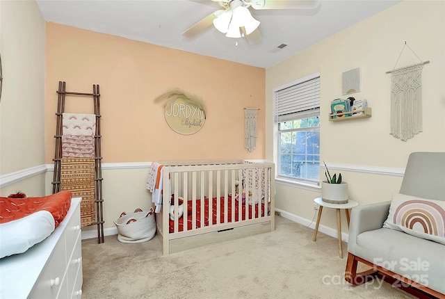 bedroom with baseboards, a ceiling fan, visible vents, and light colored carpet