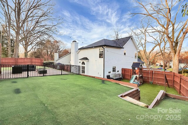 view of yard with a playground and a fenced backyard