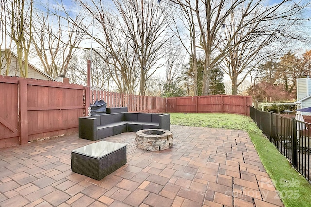 view of patio / terrace featuring an outdoor living space with a fire pit and a fenced backyard