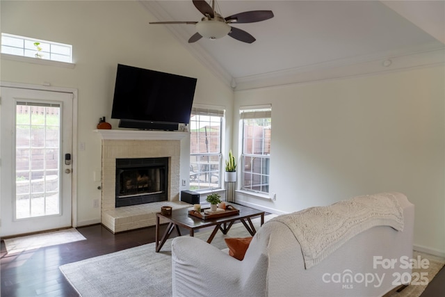 living room with high vaulted ceiling, a fireplace, a ceiling fan, and a healthy amount of sunlight