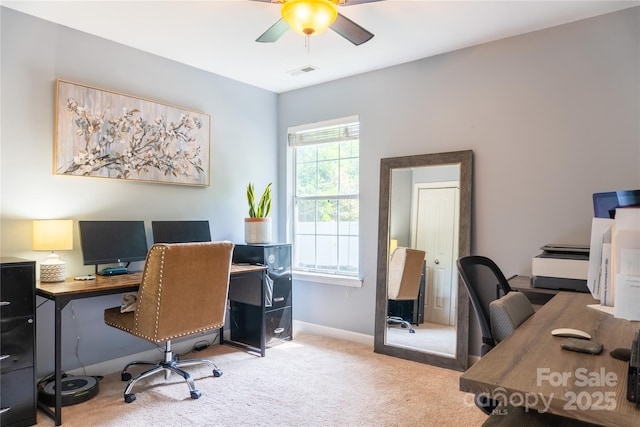 carpeted office space featuring visible vents, baseboards, and ceiling fan