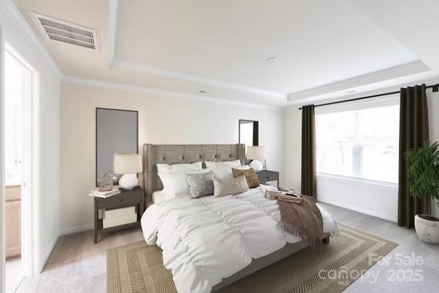 bedroom featuring ornamental molding and a raised ceiling