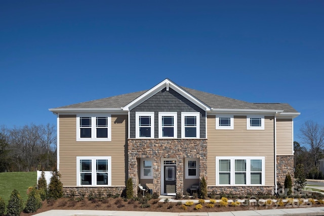 craftsman inspired home featuring stone siding