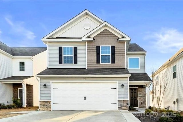 craftsman-style home featuring driveway, stone siding, and an attached garage