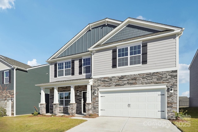 craftsman-style house featuring a garage and a front yard