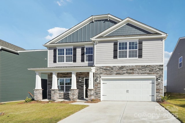 craftsman inspired home featuring a garage, a porch, and a front lawn