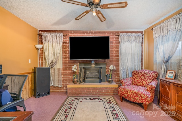 living room with ceiling fan, carpet floors, a wood stove, and a textured ceiling