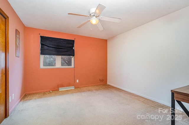 spare room featuring light colored carpet and ceiling fan