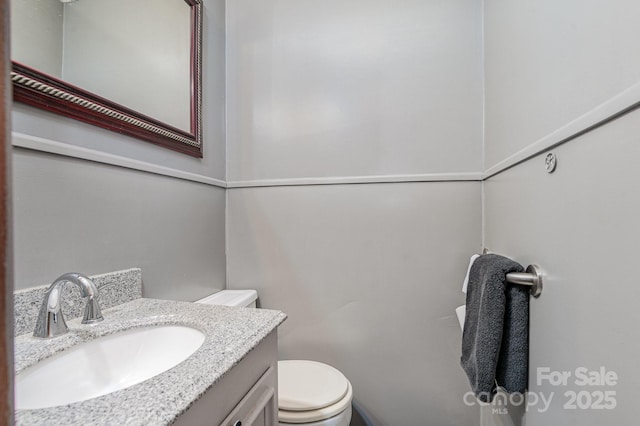 bathroom featuring vanity and toilet