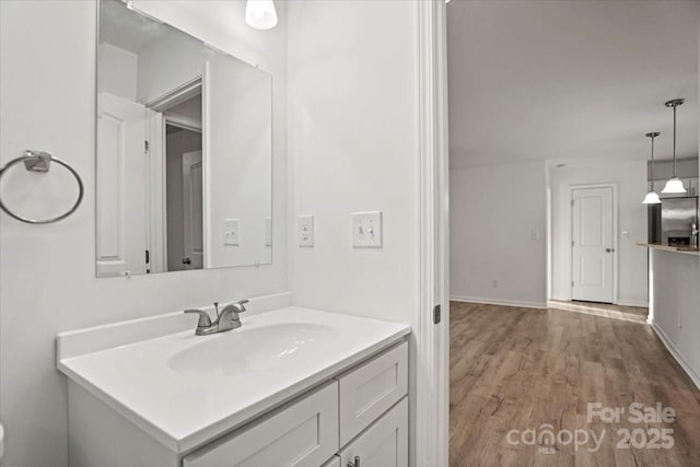 bathroom with hardwood / wood-style flooring and vanity