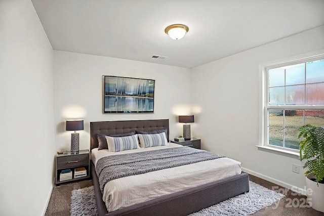 bedroom featuring multiple windows and dark colored carpet