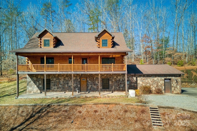 cabin with stone siding and log exterior