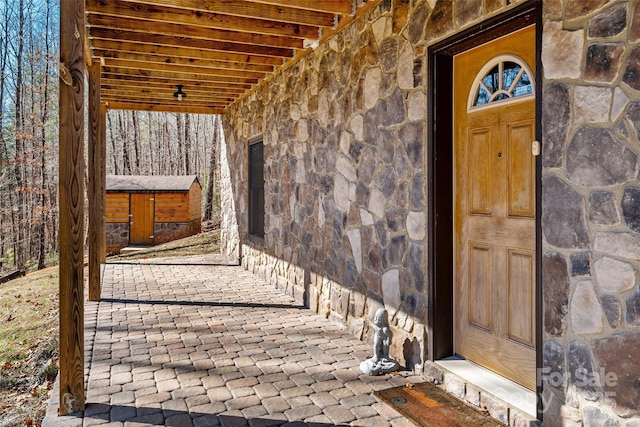 doorway to property with stone siding