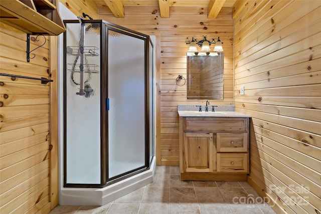 bathroom with a stall shower, wooden walls, tile patterned flooring, vanity, and beam ceiling