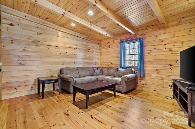 living area with beamed ceiling, wooden ceiling, and light wood-style flooring