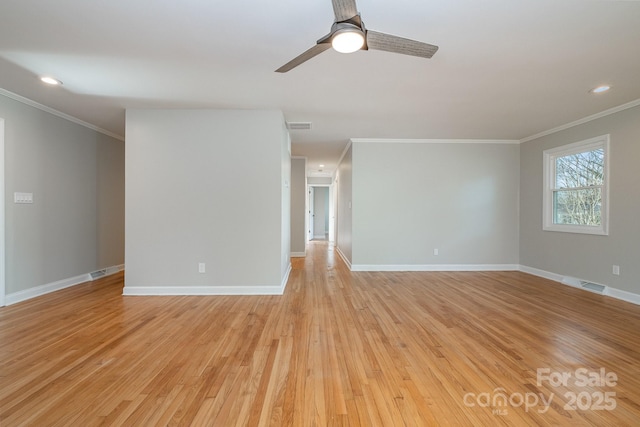 empty room featuring ornamental molding, ceiling fan, and light wood-type flooring