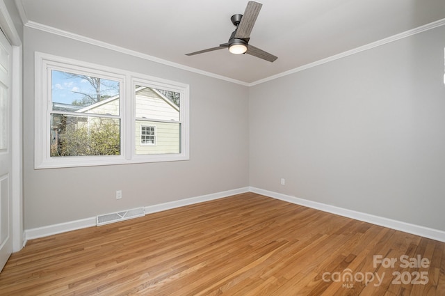 unfurnished room featuring light wood finished floors, baseboards, visible vents, and crown molding