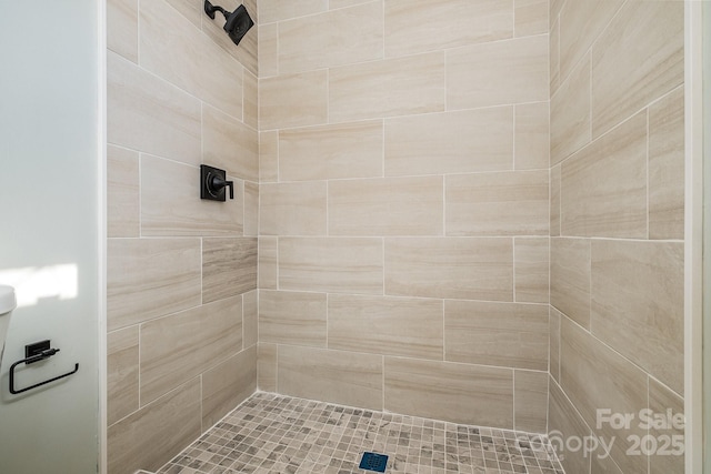 bathroom with a tile shower