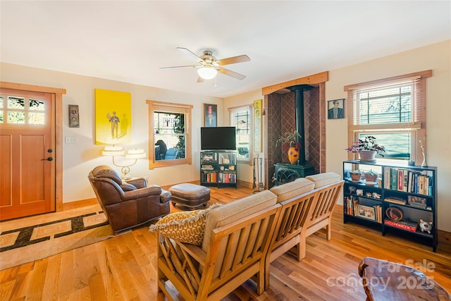 14 Drake St, Asheville, NC 28806 - living room featuring a wood stove, a ceiling fan, and light wood finished floors