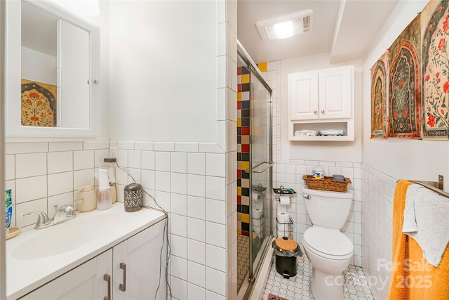 14 Drake St, Asheville, NC 28806 - full bathroom featuring tile walls, a shower stall, toilet, vanity, and tile patterned flooring