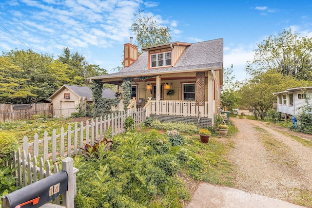 14 Drake St, Asheville, NC 28806 - bungalow-style home featuring a porch, a chimney, fence, a detached garage, and dirt driveway