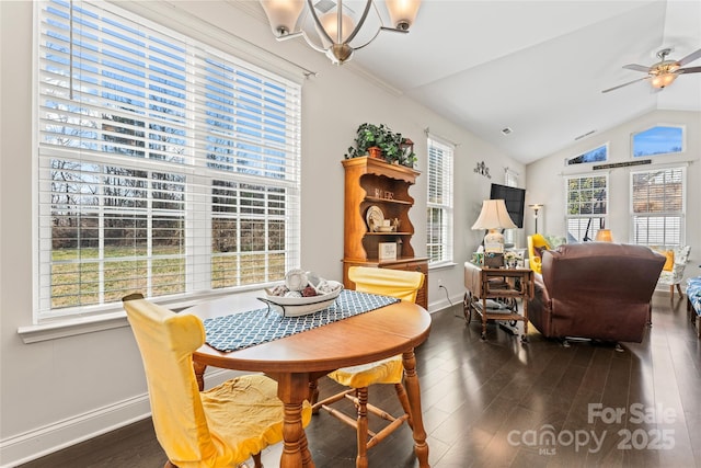 dining room with vaulted ceiling, dark hardwood / wood-style floors, and ceiling fan