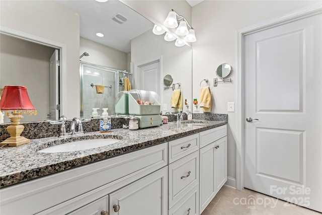 bathroom featuring walk in shower, tile patterned floors, and vanity