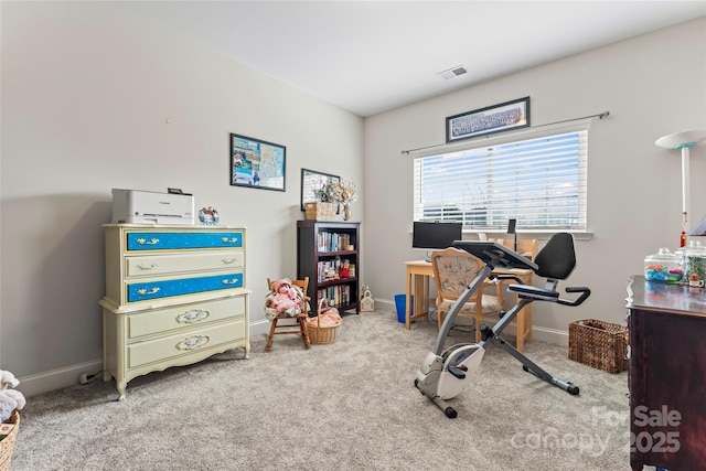 exercise room featuring light carpet