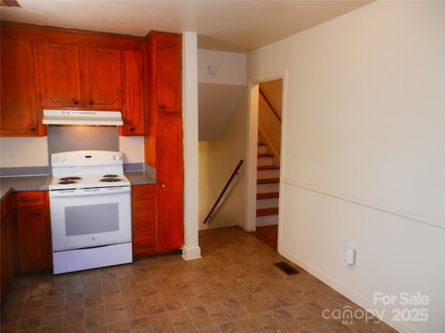 kitchen with light countertops, white range with electric cooktop, visible vents, and under cabinet range hood