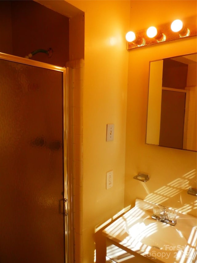 full bath featuring a shower stall and a sink