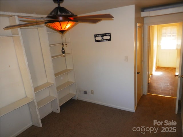 unfurnished dining area featuring dark colored carpet