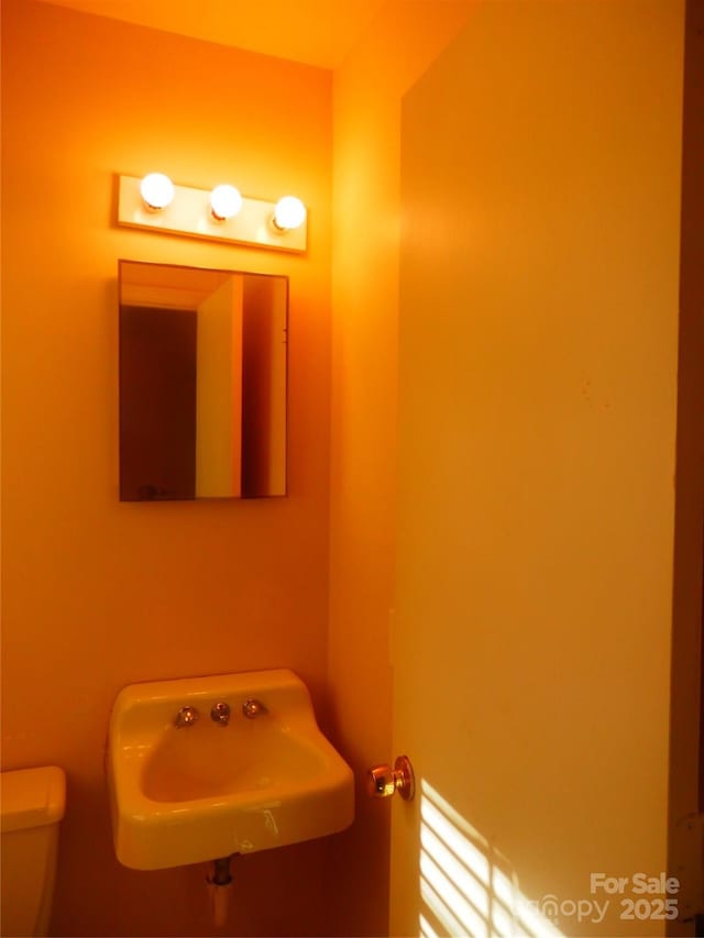 bathroom featuring toilet and a sink