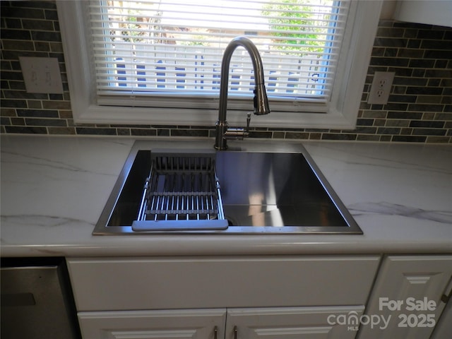 101 Colony Acres Dr, Charlotte, NC 28217 - kitchen view of a sink, decorative backsplash, and white cabinetry