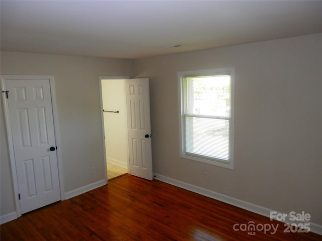 101 Colony Acres Dr, Charlotte, NC 28217 - unfurnished bedroom featuring wood finished floors and baseboards