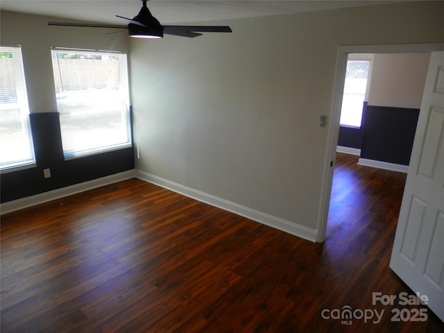 101 Colony Acres Dr, Charlotte, NC 28217 - empty room with a ceiling fan, healthy amount of natural light, dark wood finished floors, and baseboards
