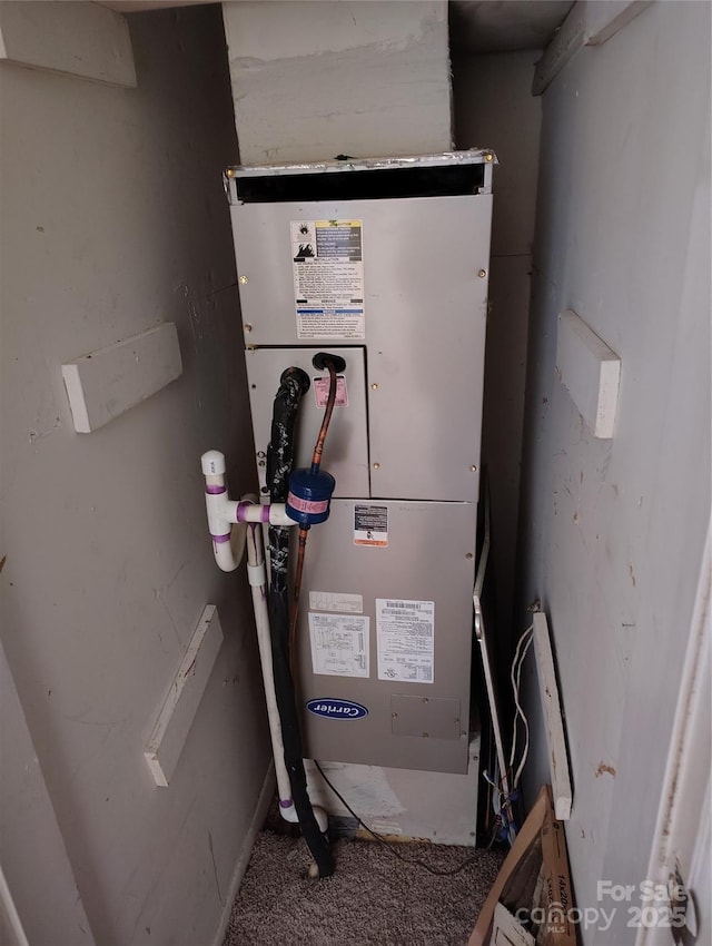 utility room featuring heating unit