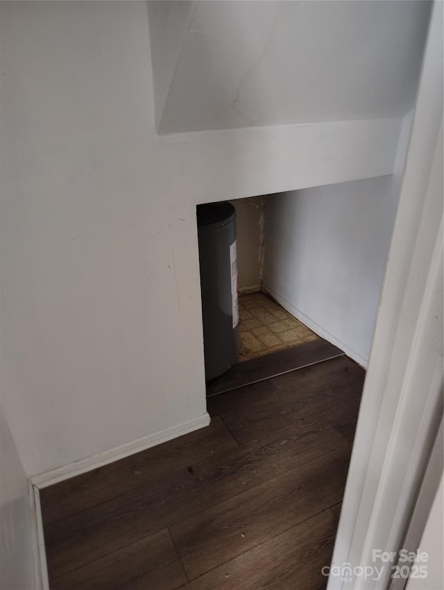 stairway featuring lofted ceiling and hardwood / wood-style floors