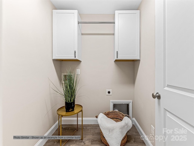 laundry room with electric dryer hookup, baseboards, cabinet space, and wood finished floors