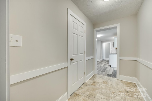 corridor with a textured ceiling