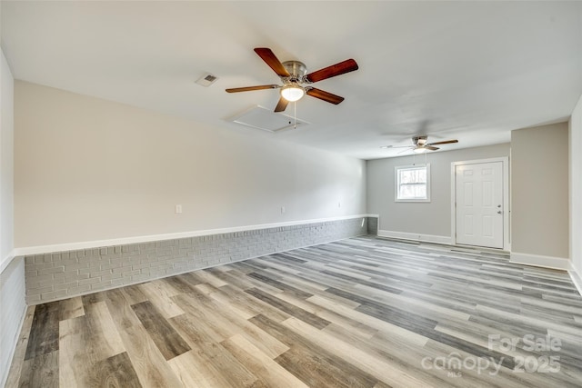 empty room featuring ceiling fan and light wood-type flooring