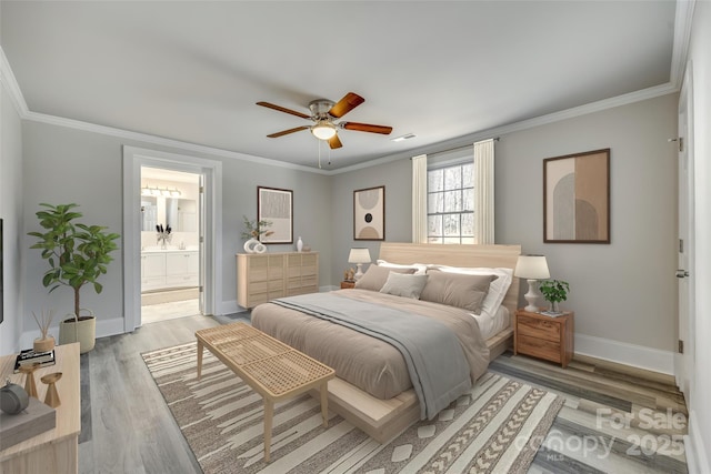 bedroom with crown molding, ceiling fan, connected bathroom, and light wood-type flooring