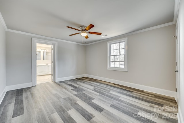 unfurnished room featuring crown molding, ceiling fan, and light wood-type flooring