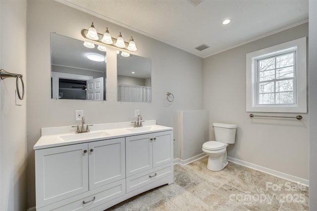 bathroom featuring vanity, crown molding, and toilet